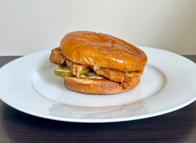 poeyes spicy blackened chicken sandwich on a white plate