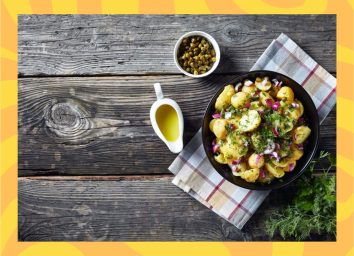 a photo of a bowl of potato salad on a picnic table with a designed yellow border
