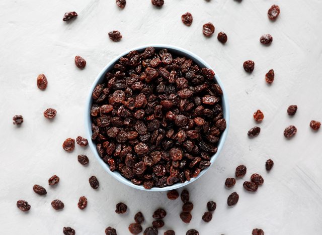 Dried Brown Raisins in a Bowl, top view. Flat lay, overhead, from above.