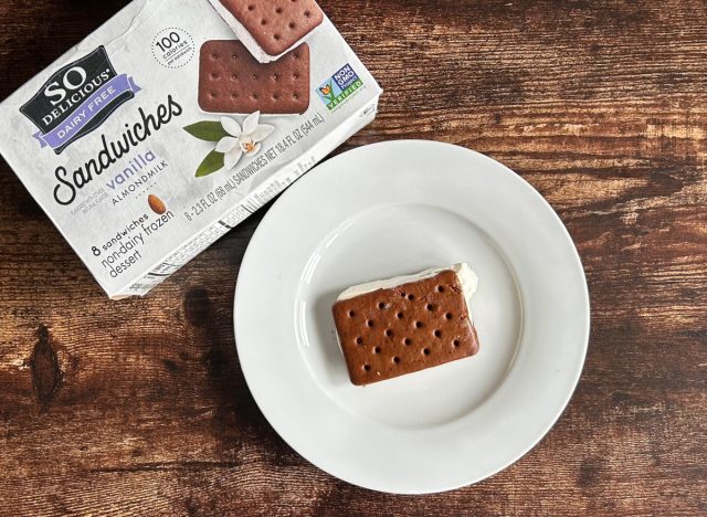 a box of so delicious dairy-free vanilla almondmikl sandwiches next to a plate with the ice cream sandwich