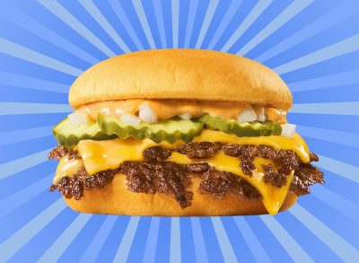 The new "Sonic Smasher" burger, featuring two smashed patties, cheese, pickles and sauce, set against a vibrant blue background