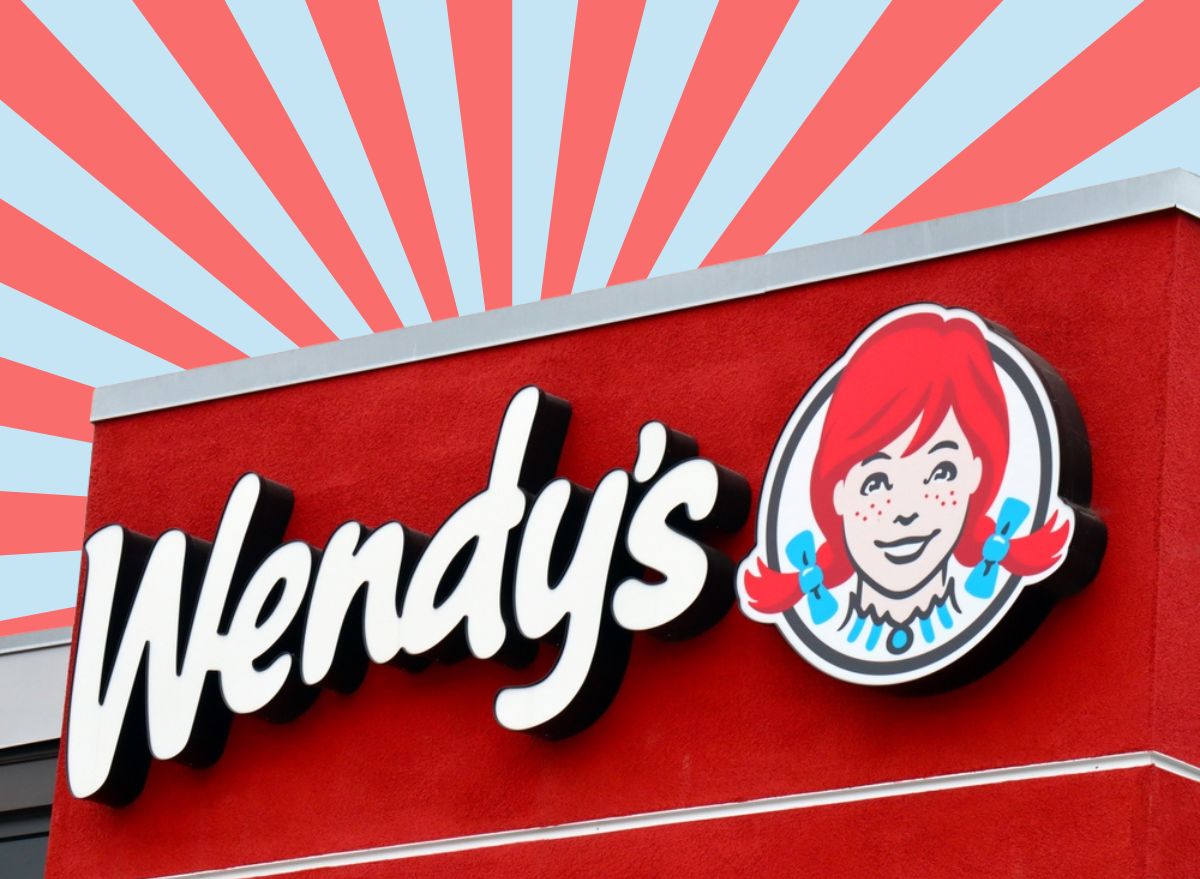 wendy's sign in front of a red and blue striped background