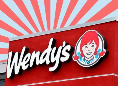 wendy's sign in front of a red and blue striped background