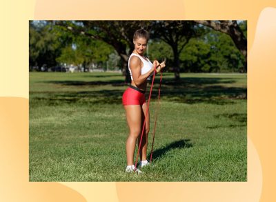 woman doing resistance band bicep curls