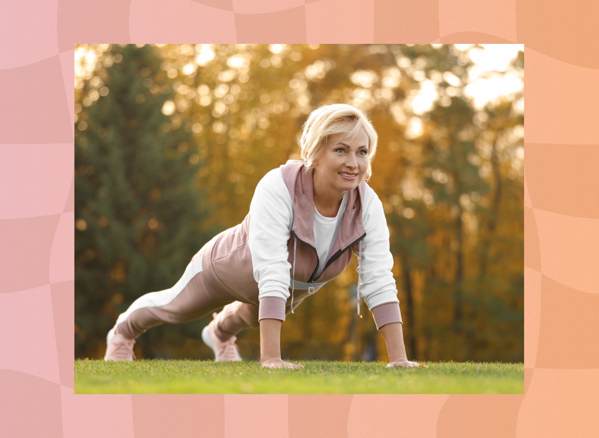 fit mature woman doing pushups or high planks outdoors on the grass