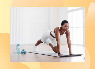 woman doing mountain climbers exercise in bright living space on a yoga mat