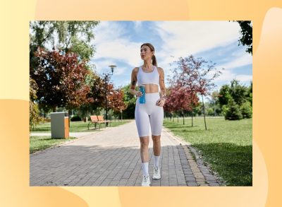 fit woman walking outdoors for exercise on sunny day along path in park