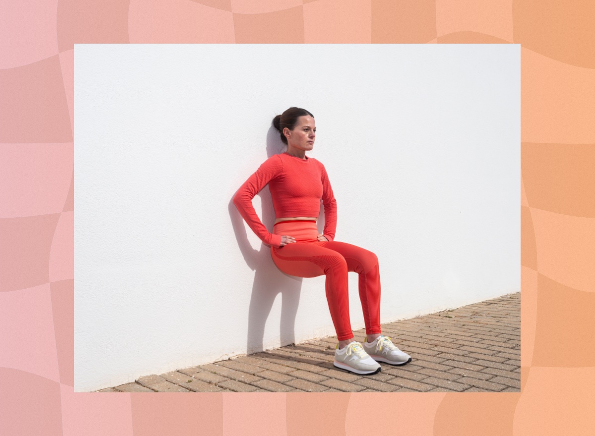 focused woman doing wall Pilates