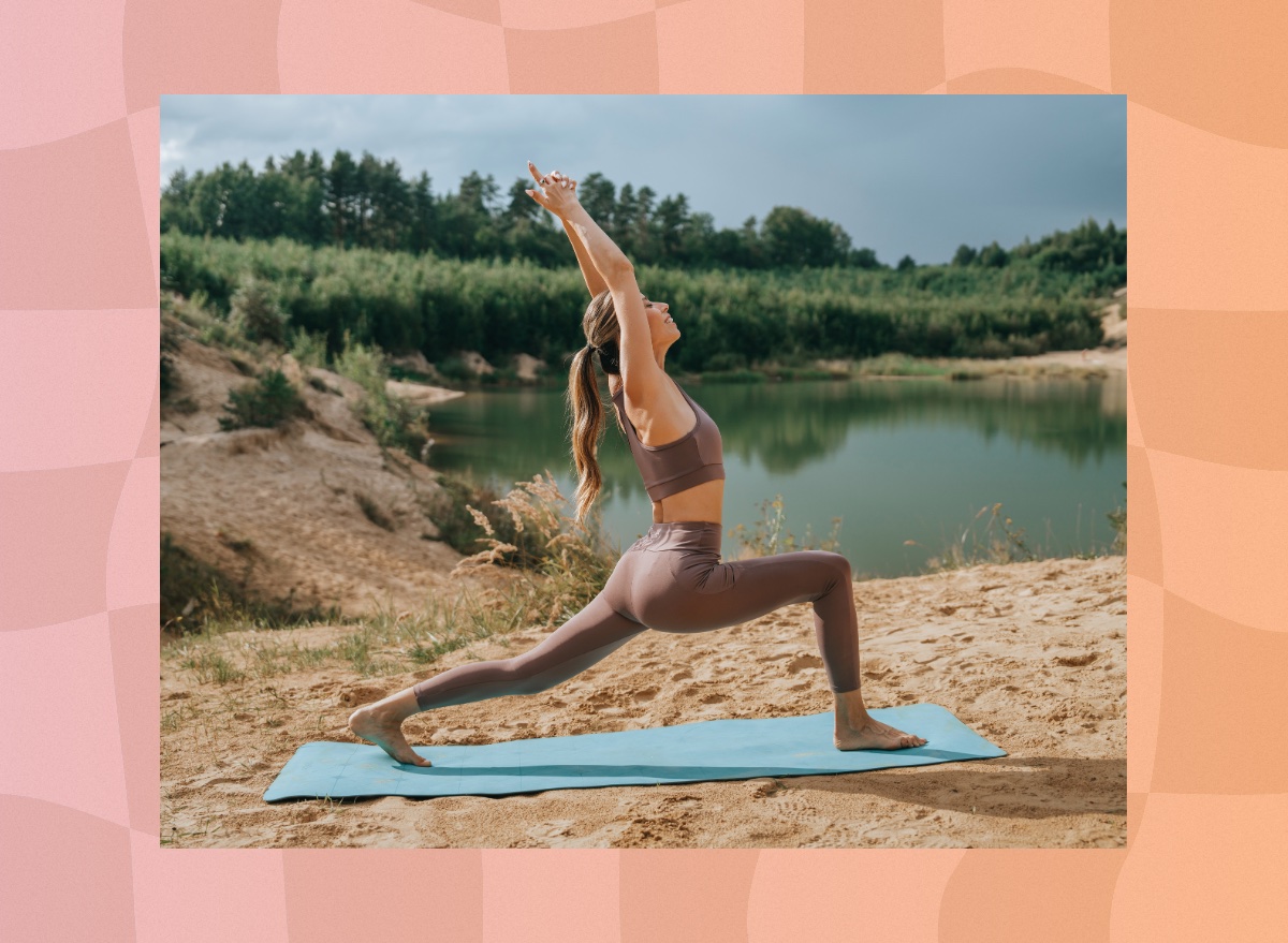 fit woman doing yoga workout on her mat outdoors