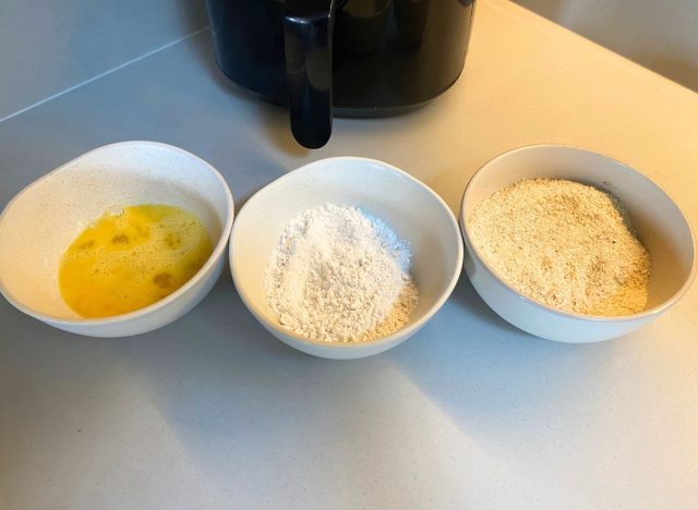 three bowls in front of an air fryer