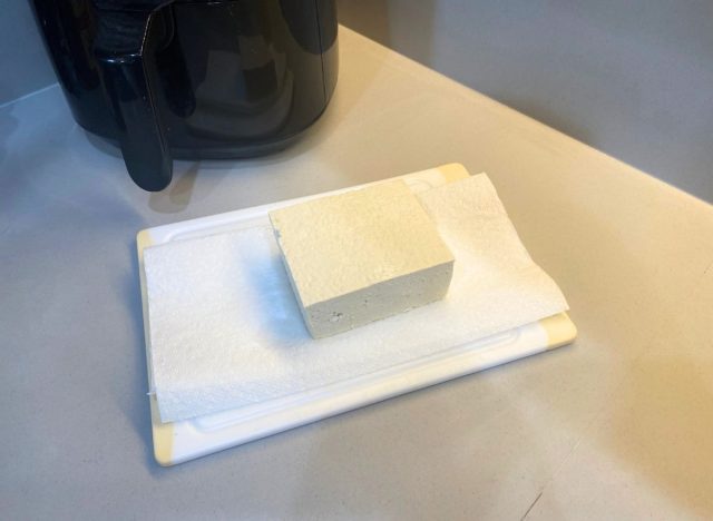 block of tofu on a cutting board