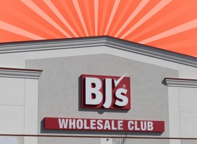 The storefront of B G's Wholesale set against a vibrant orange background