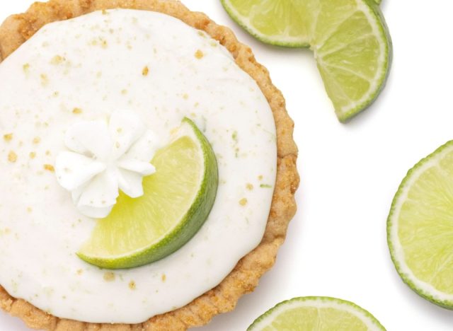 Crumbl Keylime Pie Cookie on white background with lime wedges