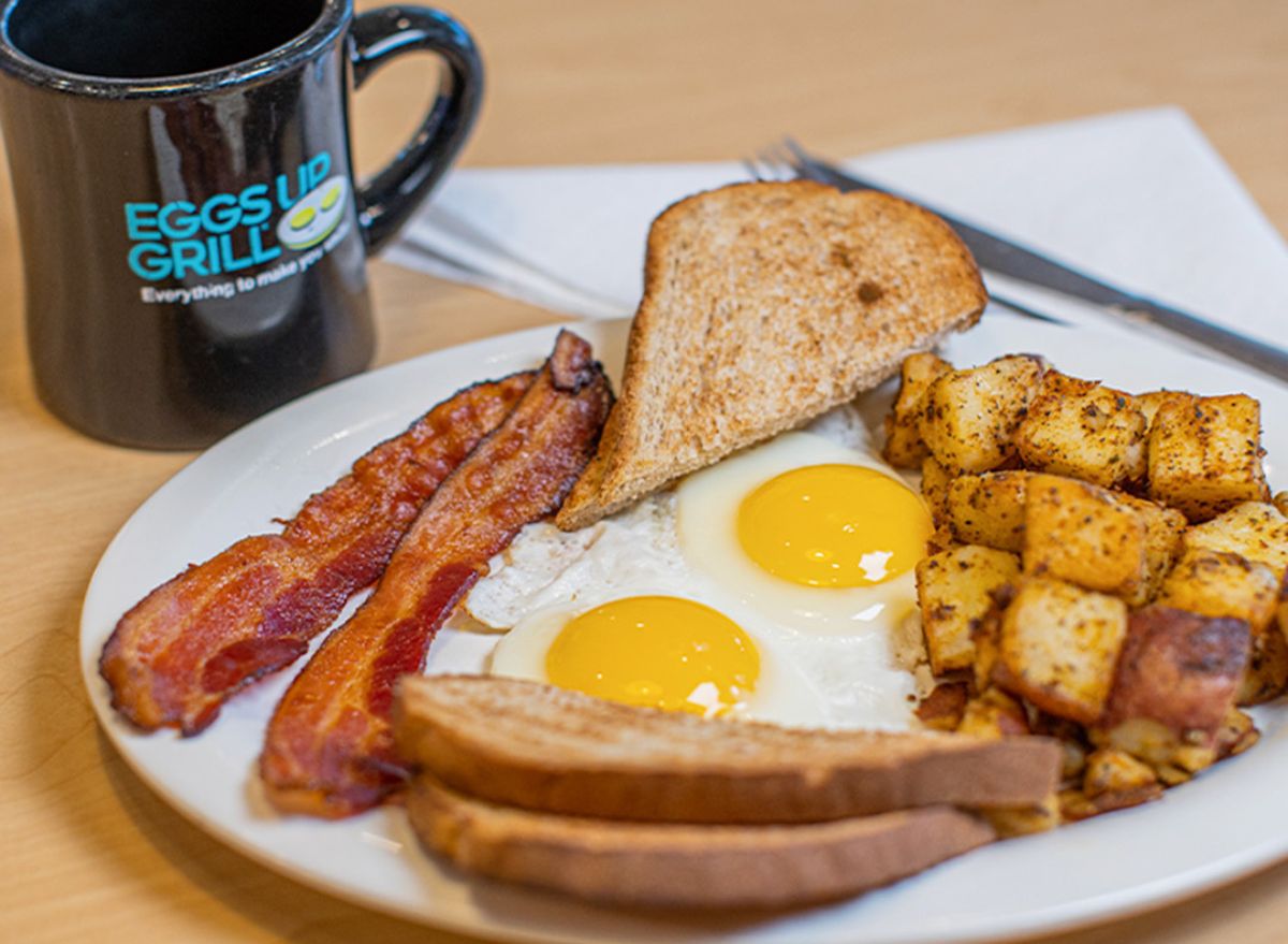 Eggs Up Grill breakfast platter and coffee cup on table