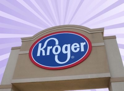 Signage bearing the red, white, and blue Kroger logo set against a virbant purple background