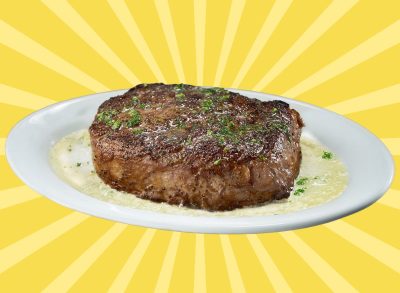 Broiled steak on a butter-drenched white plate at Ruth's Chris Steak House