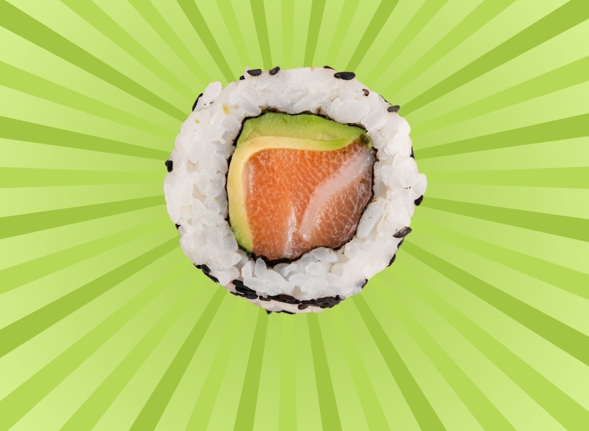 A slice of California roll sushi set against a vibrant green background