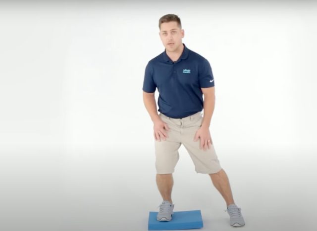 man demonstrating balance pad exercises