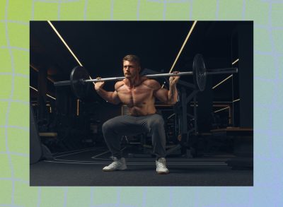 fit, muscular man doing barbell back squat exercise in dimly lit weight room