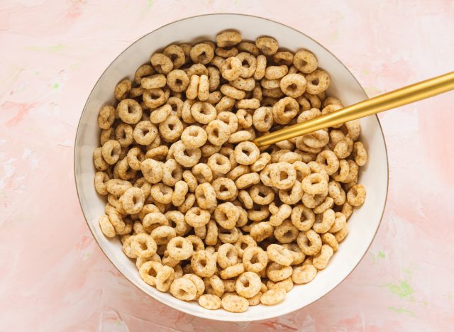 Bowl of Cheerios on pink background