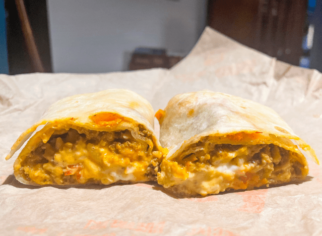 cheesy double beef cut in half on wrapper