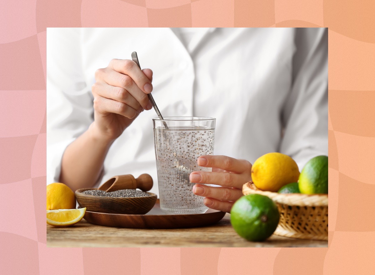 close-up of woman mixing chia seed water on table with limes and lemons