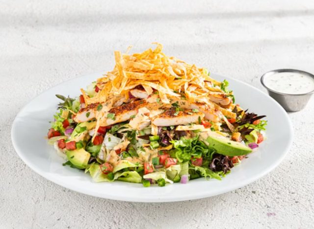 chili's santa fe salad on a table with dressing on the side