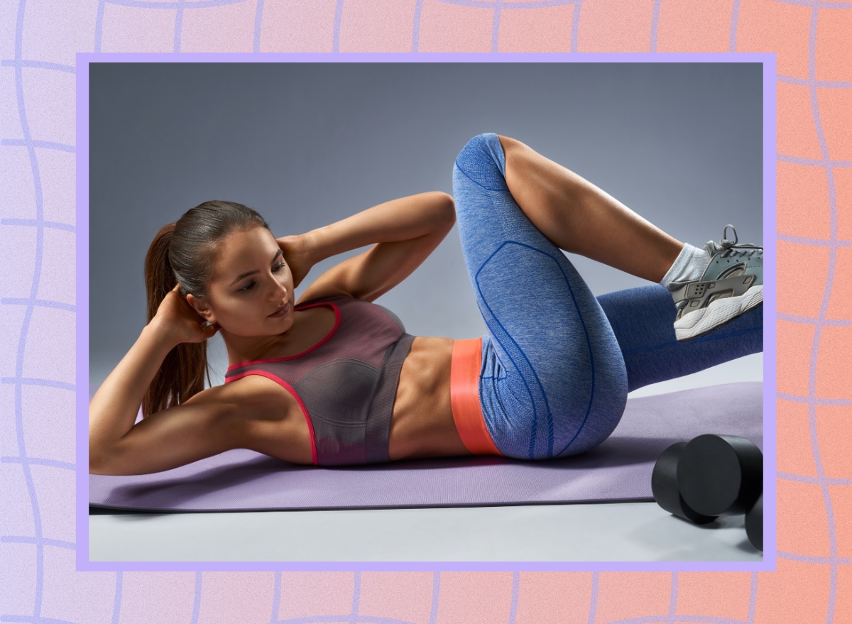 fit woman doing a criss-cross Pilates exercise on workout mat