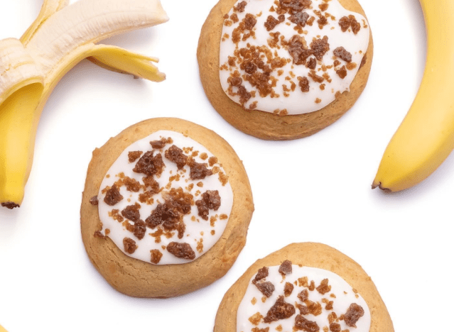 crumbl banana bread cookies surrounded by bananas on a white background