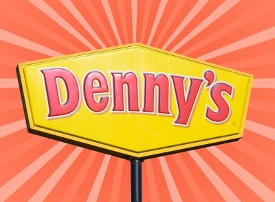 denny's sign set against a designed red background