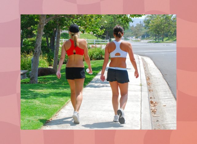 female friends walking outdoors on sidewalk for exercise on sunny day