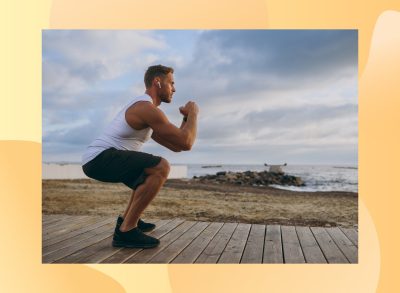 fit man doing squats on boardwalk by the beach