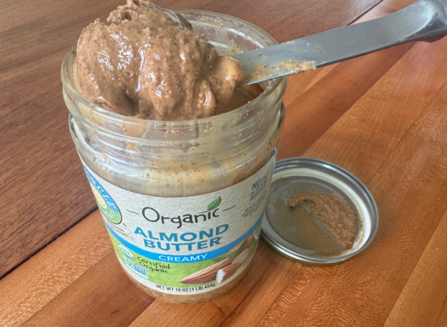 an open jar of full circle almond butter with a knife in it 