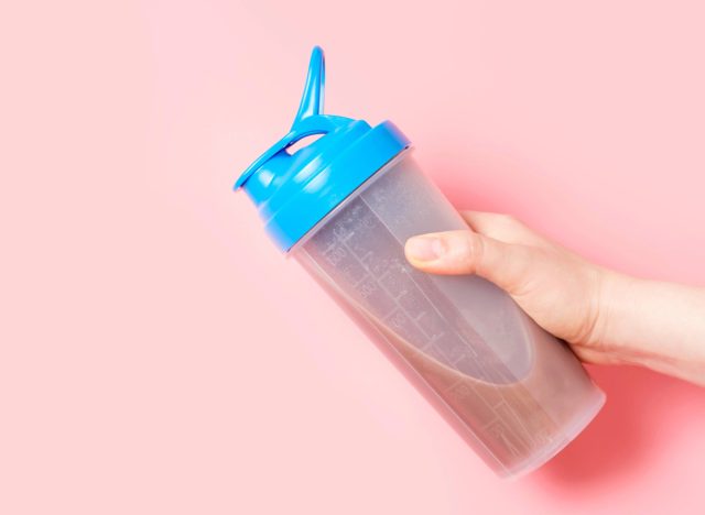 close-up hand holding protein shake