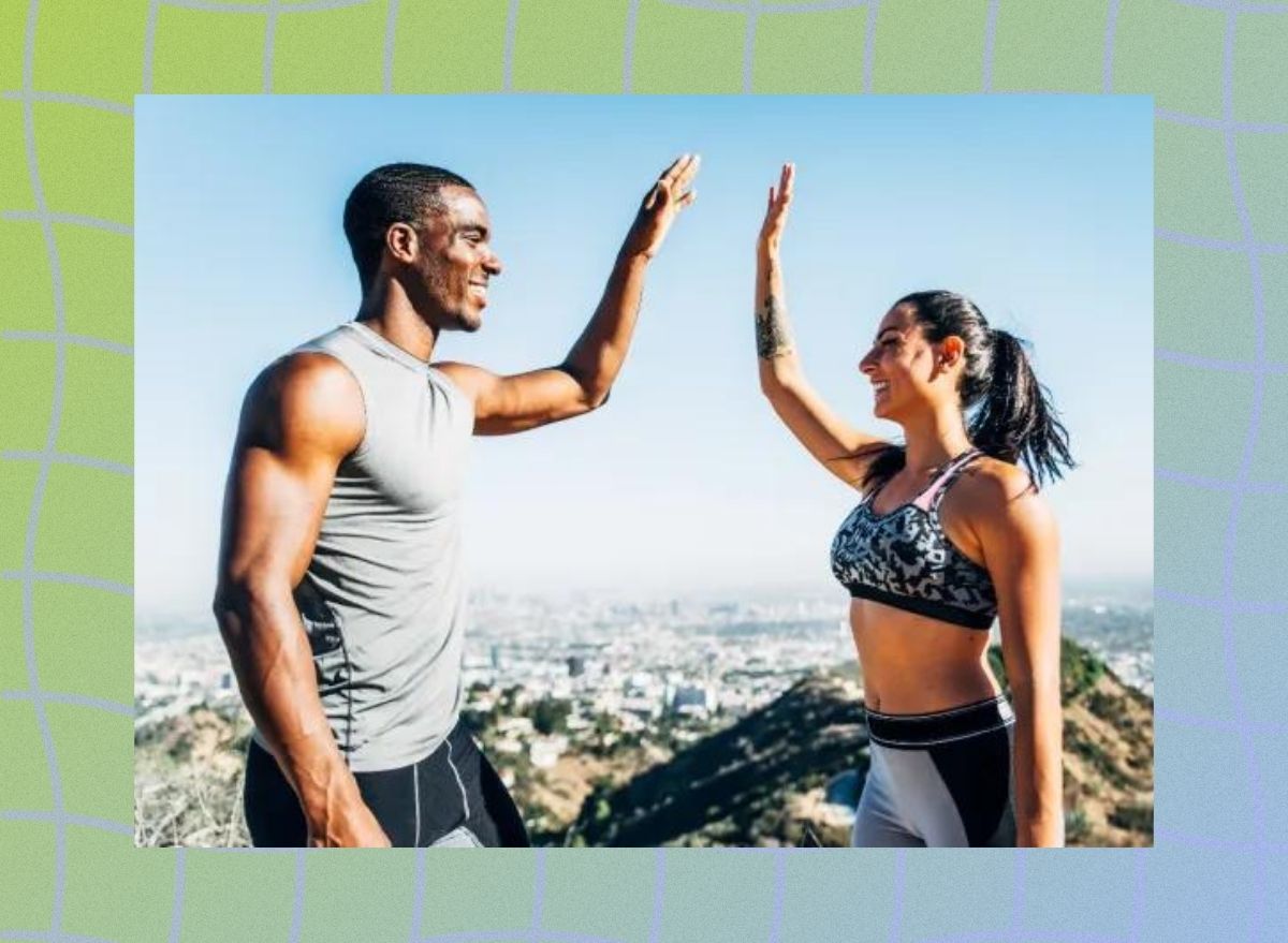 a photo of two fit people at the top of a mountain high-fiving each other on a designed greenish background