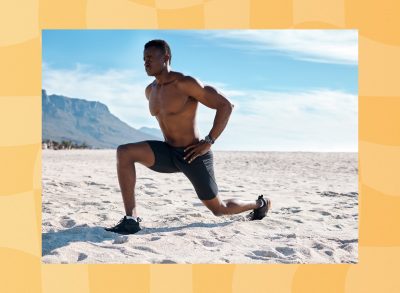 fit man doing walking lunges at the beach on sunny day