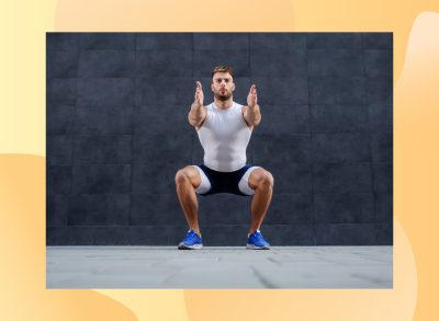 fit, focused man doing a bodyweight squat outside on pavement