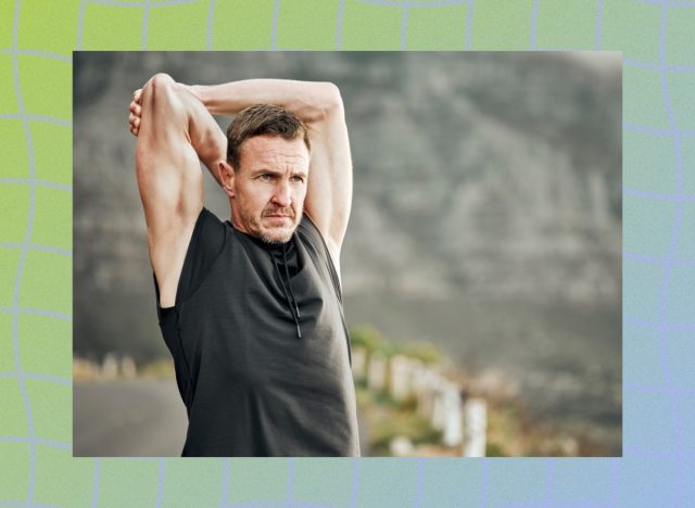 mature man stretching outdoors while on a run