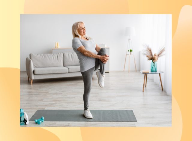 mature woman doing a single-leg balance exercise in bright living space