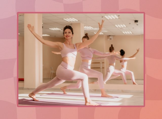 mature, fit women wearing pink workout attire in yoga class in bright fitness room with mirrors