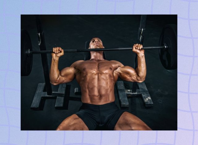 fit, muscular man doing barbell bench press