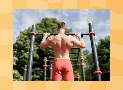 fit man doing pull-ups outdoors at park