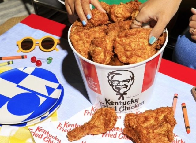 people taking kfc fried chicken from bucket