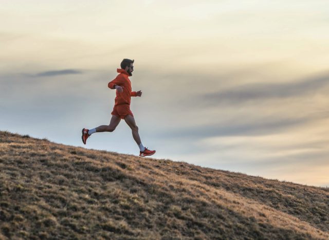 fit man running downhill