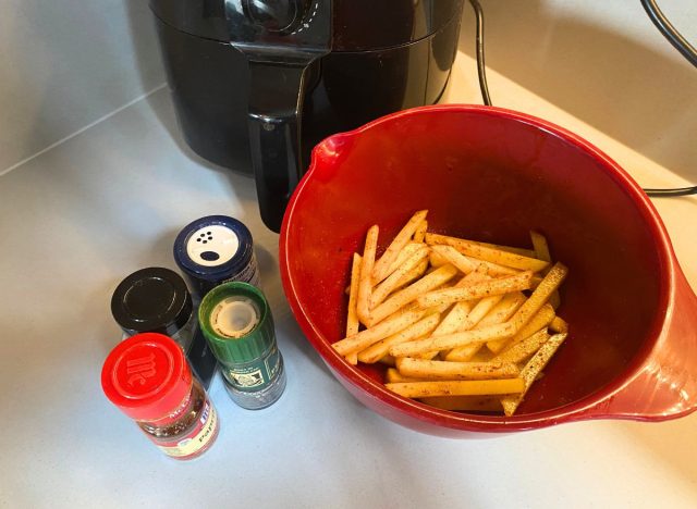 seasoned fries in a red bowl