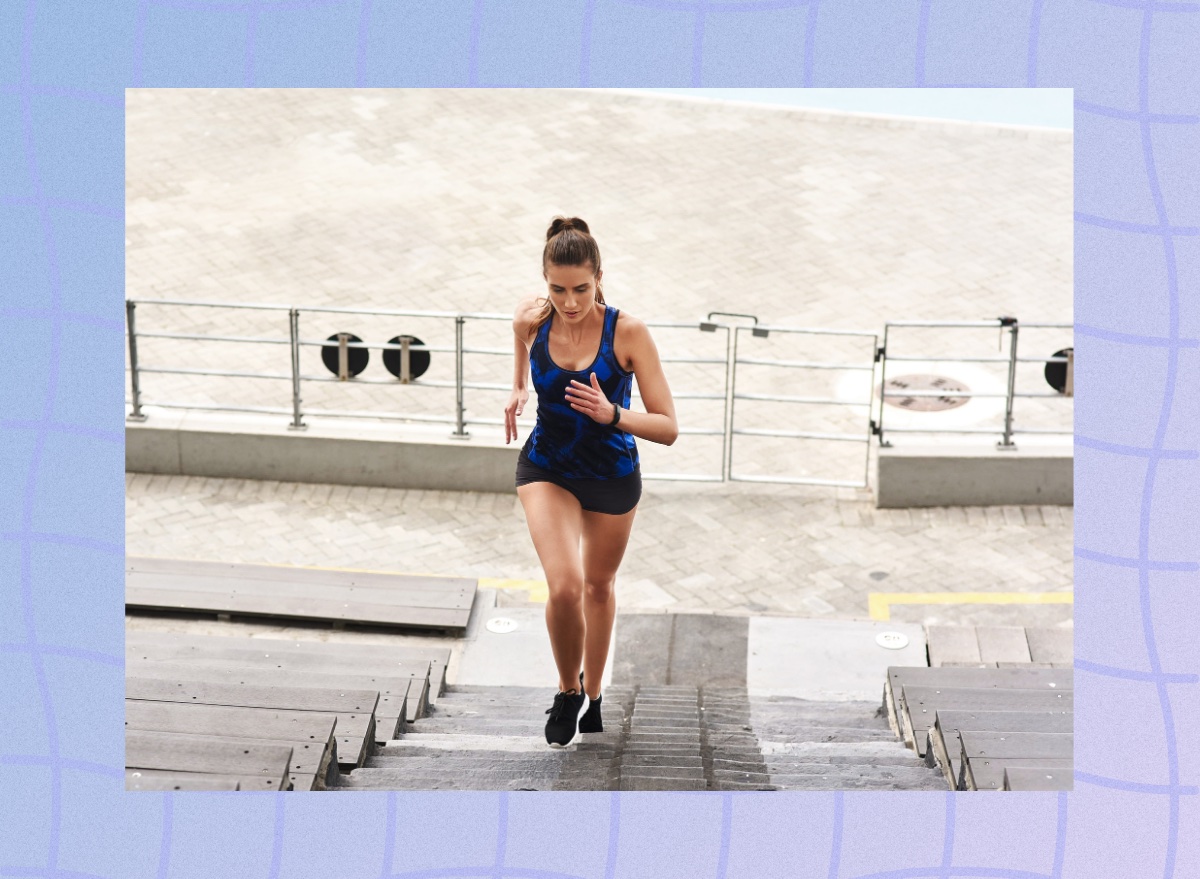 fit, focused woman doing stair workout on bleacher steps