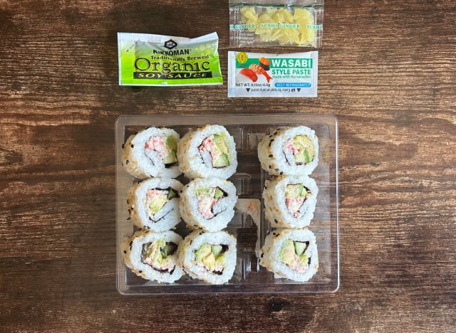 plastic container with Trader Joe's california rolls and packets of soy sauce, wasabi, and ginger