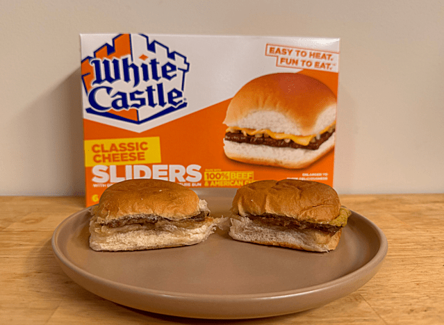 a box of white castle sliders with some on a plate 