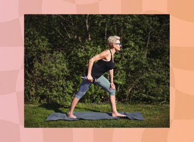 mature fit woman doing dumbbell exercise outdoors on yoga mat