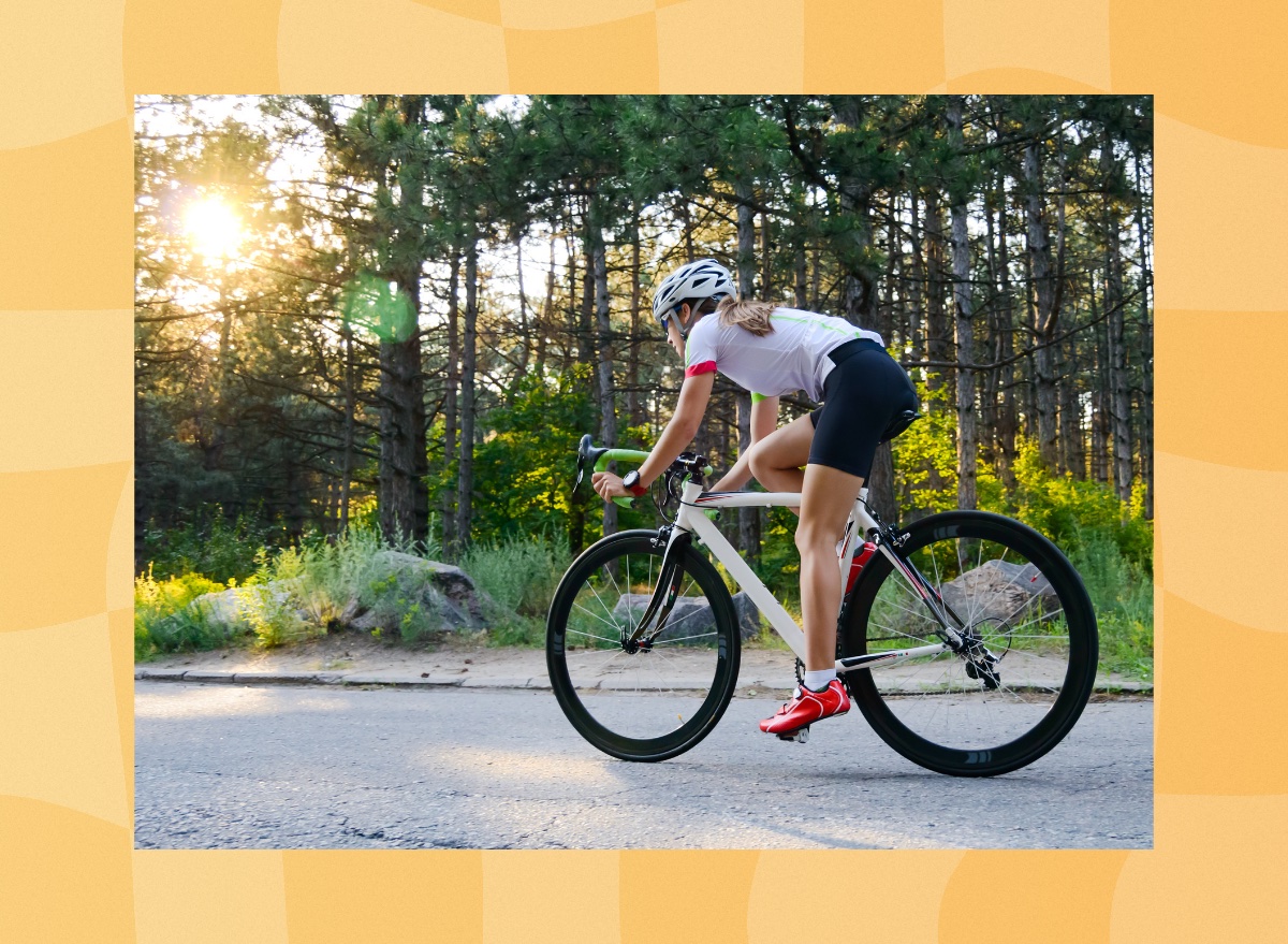 woman cycling outdoors on paved path